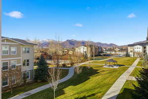 View of property's community featuring a lawn, a residential view, and a mountain view
