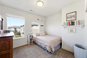 Carpeted bedroom featuring baseboards