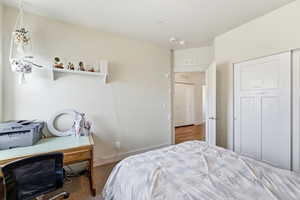Bedroom featuring a closet and a desk