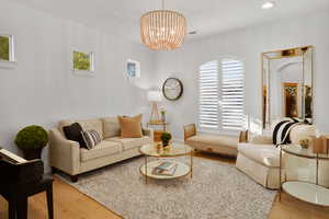 Living room with wood finished floors and a chandelier