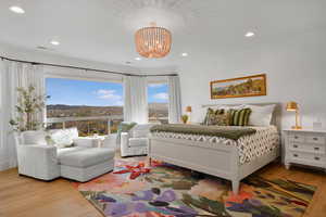 Bedroom featuring wood finished floors, recessed lighting, a mountain view, and a chandelier