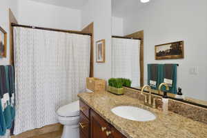 Full bath with a shower with curtain, vanity, and light tile patterned flooring