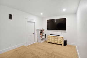 Carpeted bedroom with baseboards and recessed lighting