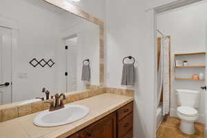 Full bathroom with vanity and shower / bathtub combination with curtain