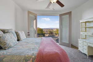 Carpeted bedroom featuring access to outside and a ceiling fan