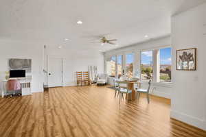Dining area featuring light wood-style flooring, a ceiling fan, a textured ceiling, recessed lighting, and an office area