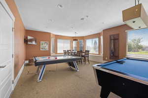 Game room featuring a textured ceiling and billiards
