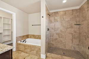 Bathroom with a garden tub, a shower stall, vanity, and recessed lighting