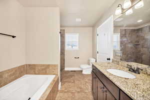 Full bath featuring a bath, healthy amount of natural light, and vanity
