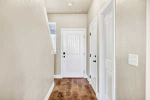Corridor with dark wood finished floors and baseboards
