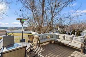 Wooden terrace with a residential view, a fenced backyard, an outdoor hangout area, and outdoor dining area