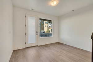 Unfurnished room featuring light wood-type flooring and baseboards
