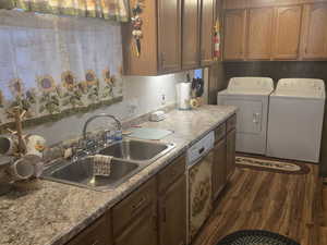 Kitchen featuring brown cabinetry, dishwasher, and washer and clothes dryer