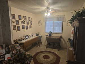 Dining room with light carpet and a ceiling fan