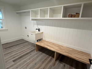 Laundry room with light wood finished floors and hookup for a washing machine