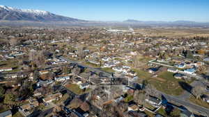 Aerial view of property's location featuring nearby suburban area and a mountain backdrop