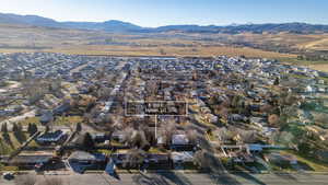 Aerial view of property and surrounding area featuring nearby suburban area