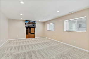 Spare room with recessed lighting and carpet floors