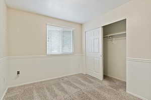 Unfurnished bedroom with carpet and a closet