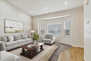 Living room featuring light wood-style flooring and recessed lighting