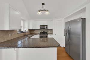 Updated kitchen with freshly painted & plentiful cabinets, granite counter tops, walk-in pantry.