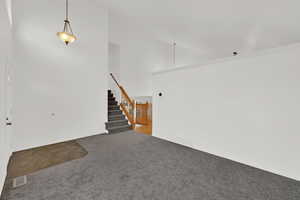 Front entry room with new carpet and fresh paint. Vaulted ceilings and loads of natural light.