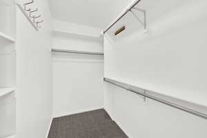 Walk-in closet with new carpet, in primary bedroom.