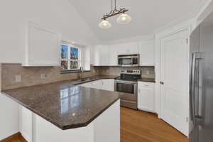 Updated kitchen with freshly painted & plentiful cabinets, granite counter tops, walk-in pantry.