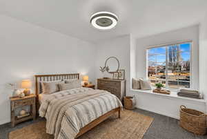 Virtually Staged upstairs bedroom- storage in the window seat, fresh paint and new carpet.