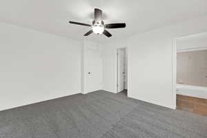 Primary bedroom with en-suite, walk-in closet and new carpet with fresh paint.