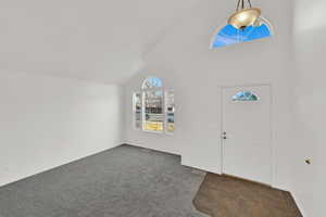 Front entry room with new carpet and fresh paint. Vaulted ceilings and loads of natural light.