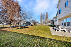 Patio area overlooking the ample yard space, full sprinkler system and shed included. Fully fenced as well.