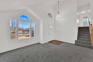 Front entry room with new carpet and fresh paint. Vaulted ceilings and loads of natural light.