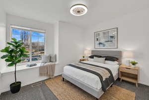 Virtually Staged upstairs bedroom- storage in the window seat, fresh paint and new carpet.