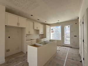 Kitchen with a kitchen island and white cabinets