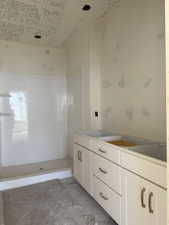 Bathroom featuring double vanity and walk in shower