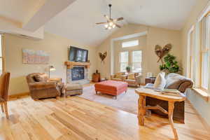 Spacious open plan living room with vaulted ceilings and gas fireplace
