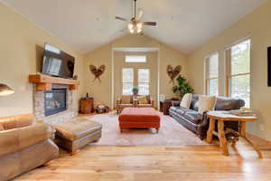 Spacious open plan living room with vaulted ceilings and gas fireplace