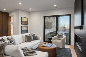 Living room with recessed lighting and light wood finished floors