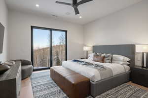 Bedroom featuring light wood-type flooring, a ceiling fan, recessed lighting, and access to exterior