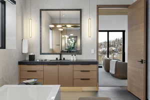 Bathroom with vanity and a tub to relax in