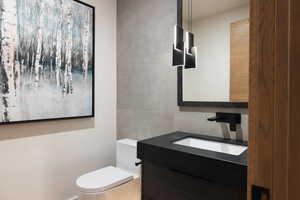 Bathroom with vanity and tile walls