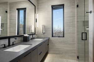 Bathroom with double vanity and a stall shower