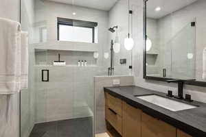 Full bathroom featuring a stall shower and vanity
