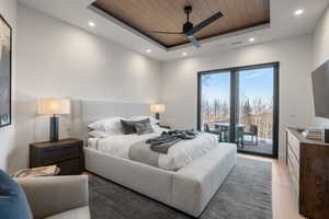Bedroom featuring wood ceiling, a raised ceiling, recessed lighting, access to exterior, and a ceiling fan