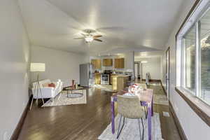 Dining space with lofted ceiling, wood-type flooring, a ceiling fan, and a chandelier