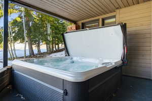 View of patio with a hot tub