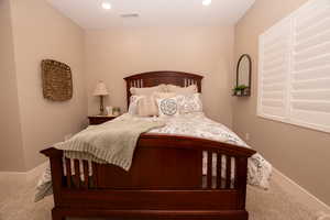 Carpeted bedroom featuring baseboards and recessed lighting