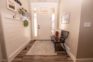 Foyer with dark wood-type flooring