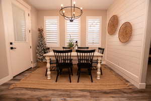 Dining space featuring wood finished floors and a chandelier